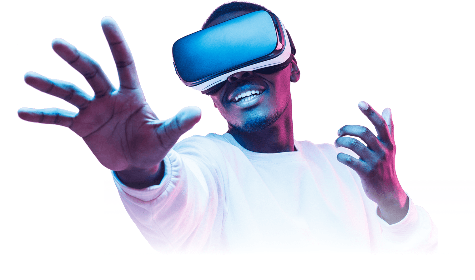 A person wearing a virtual reality headset reaches out with one hand, smiling under blue and pink lighting, dressed in a white long-sleeve shirt. The background is isolated.