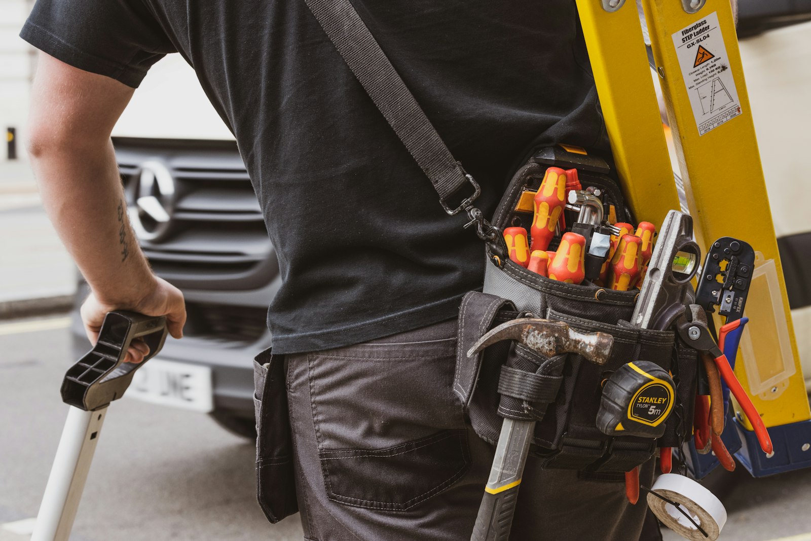 Home service technician holding a power tool on a job