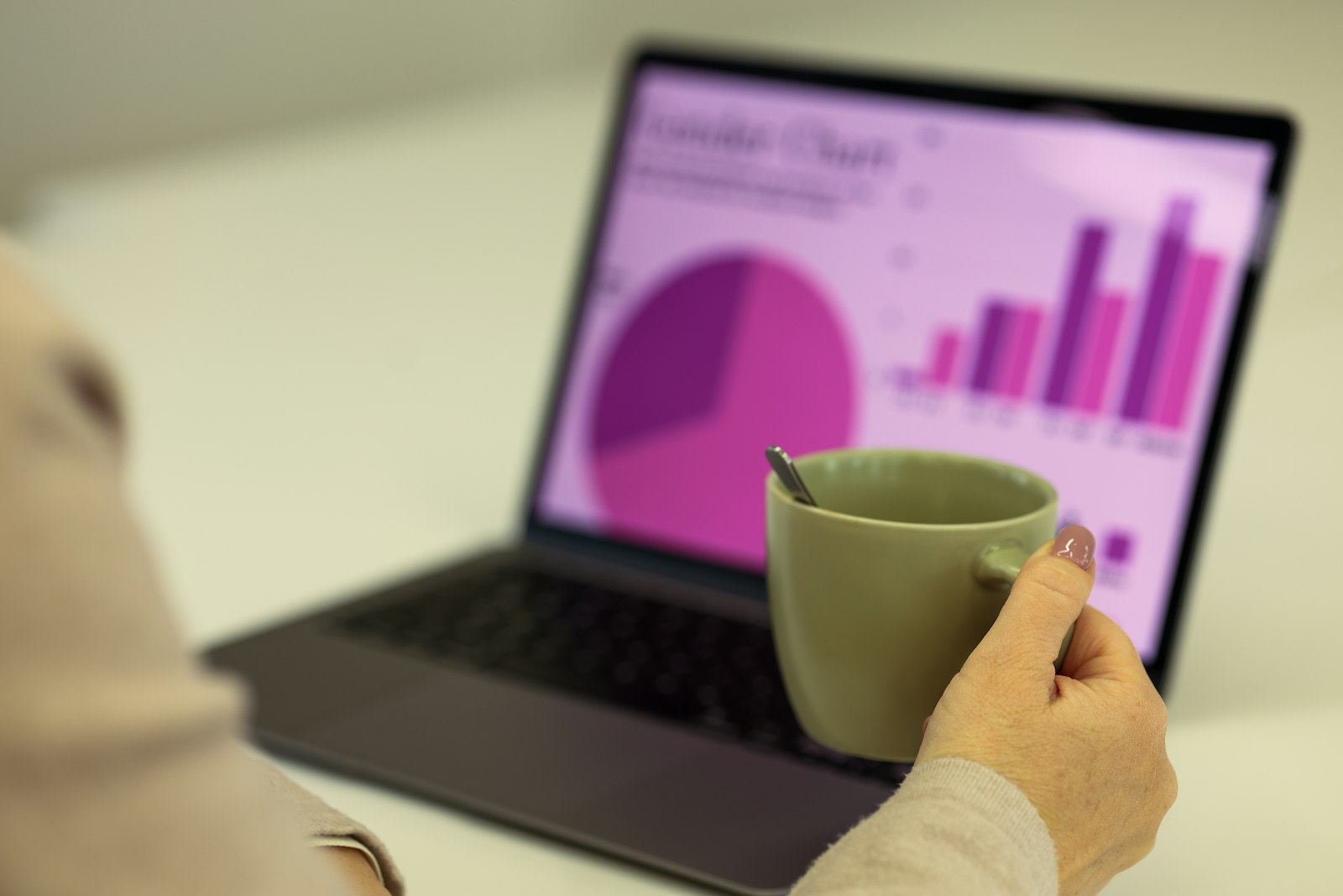 Person reviewing colorful analytics charts on a laptop